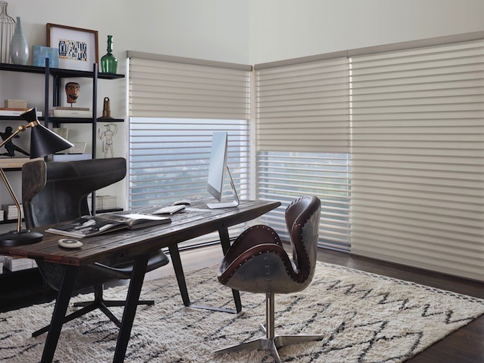 An office with a clutter-free desk and shelves.